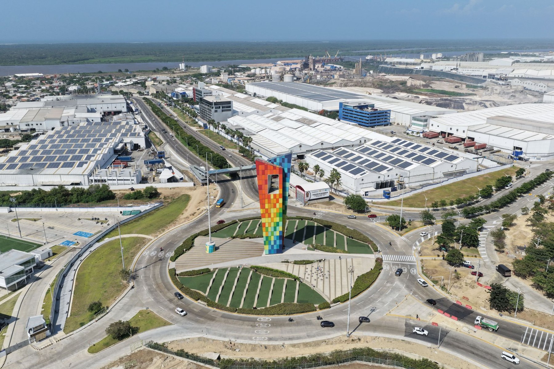 Aerial photograph of the Tecnoglass manufacturing facility in Barranquilla, Colombia, with factory buildings and solar-panel-covered roofs